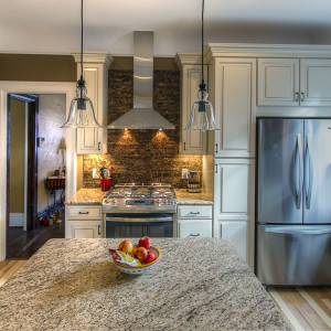 traditional-kitchen-remodel-ivory-cabinets-granite-exposed-brick