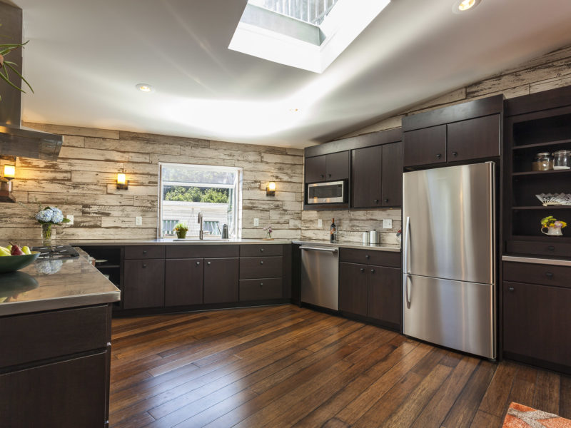 kitchen remodel-wood floors-wood look tile-accent wall-dark wood cabinets-skylight
