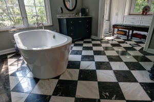 free standing tub-bathroom remodel-checkerboard tile-black and white tile-vanity cabinets