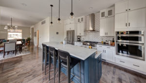kitchen remodel-white cabinets-blue cabinets-kitchen island-wood floors-pendant lights-backsplash tile-subway tile