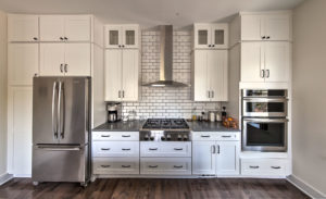 kitchen remodel-white cabinets-gray quartz countertops-kitchen vent-gas cooktop-subway tile