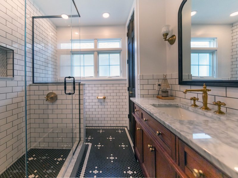 View of a newly remodeled bathroom with black and white tile.