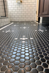 Close up of a black and white tiled bathroom floor.