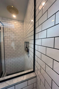 Close up of the wall tile in a newly remodeled bathroom with black and white tile.