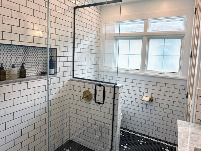 View of a newly remodeled bathroom with black and white tile.