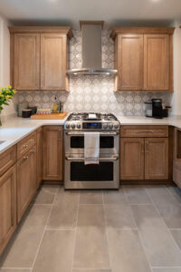 View of newly remodeled kitchen with wood cabinets and decorative backsplash tile.