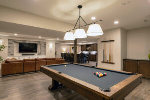 Gaming area with a pool table in a finished basement in Pittsburg.
