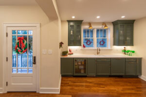 Remodeled kitchen with painted green cabinets.