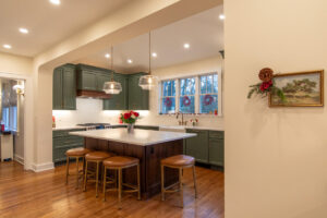 Remodeled kitchen with painted green cabinets.