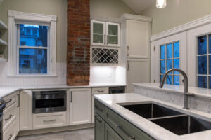 View of built-in wine storage in a newly remodeled classic white kitchen.