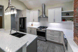 View of herringbone tile backsplash in a newly remodeled classic white kitchen.