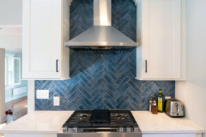 Close up view of the blue accent tile above the stove in a newly remodeled kitchen.