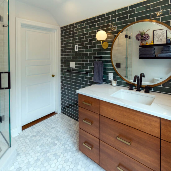 View of a recent bathroom renovation in Pittsburgh that includes a wood vanity, tile floor, custom corner shower, and floating shelves.