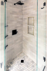 Close up of the custom tiled corner shower in a newly remodeled bathroom in Pittsburgh.