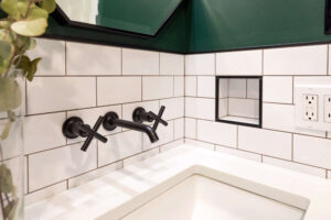 Close up of a black wall mounted faucet in a bathroom renovation in Pittsburgh.