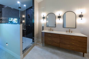 View of a beautifully remodeled bathroom with spacious walk-in shower, gorgeous vanity, and glass tile.