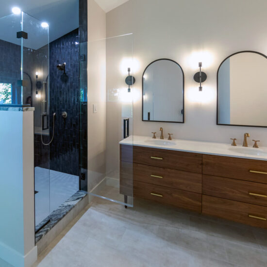 View of a beautifully remodeled bathroom with spacious walk-in shower, gorgeous vanity, and glass tile.