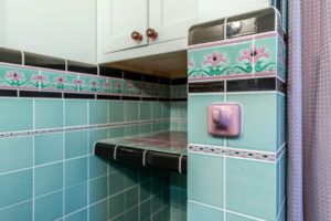 Close up view of vintage floral tile in a renovated bathroom.