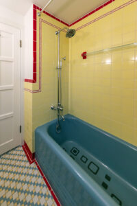Renovated bathroom with vintage tile and colored ceramic tub.