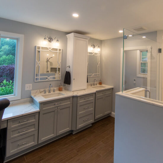 View of a newly remodeled bathroom in Pittsburgh that features an oversized shower, private water closet, dual sinks, and custom vanity.