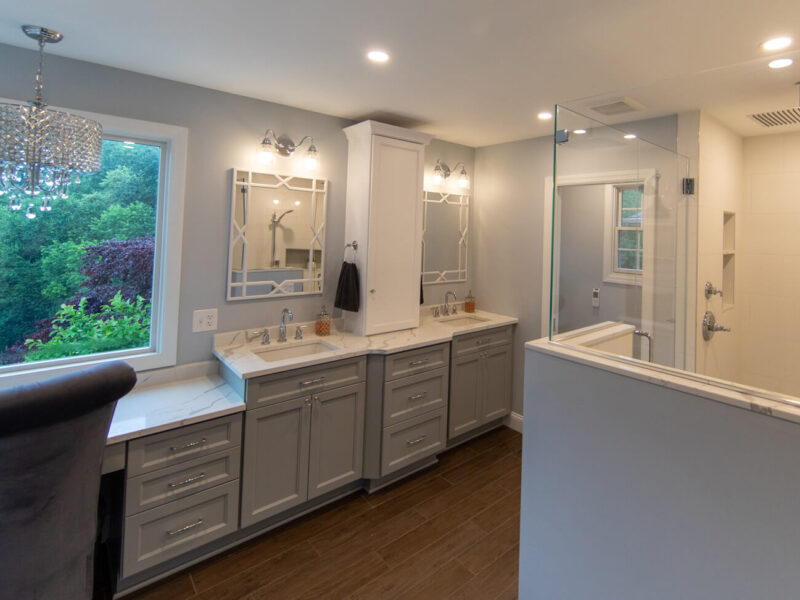 View of a newly remodeled bathroom in Pittsburgh that features an oversized shower, private water closet, dual sinks, and custom vanity.