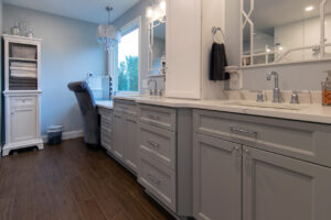 View of the dual sinks and custom vanity in a newly remodeled bathroom.