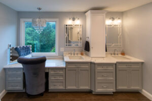 View of a custom vanity in front of a large picture window in a newly remodeled bathroom.