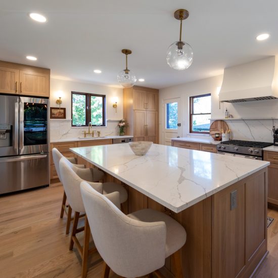 View of the large island in a remodeled kitchen in Mt. Lebanon featuring custom cabinets and a marble countertop.