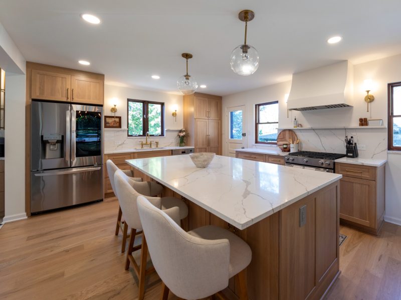 View of the large island in a remodeled kitchen in Mt. Lebanon featuring custom cabinets and a marble countertop.