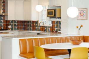 View into a newly remodeled kitchen with a bold, retro orange and yellow design.