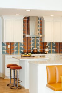 Close up view of the island and stove in a kitchen that was part of a first floor renovation in Pittsburgh.