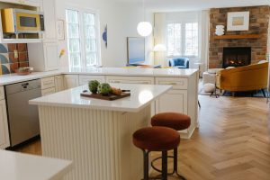 View of a family with fireplace from the kitchen of a newly remodeled home in Pittsburgh.