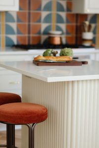 Close up view of a cutting board with bread on an island in a kitchen that was part of a first floor renovation in Pittsburgh.