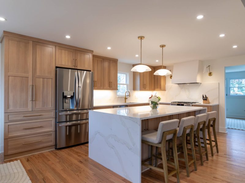 View of a beautiful kitchen renovation in Mt. Lebanon featuring new cabinets and an island with a waterfall countertop.