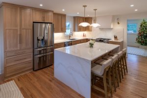 View of a beautiful kitchen renovation in Mt. Lebanon featuring new cabinets and an island with a waterfall countertop.