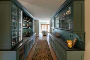 View looking through a walk-through pantry into the adjoining family room.